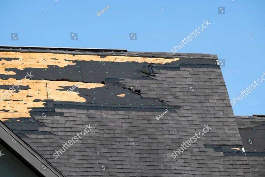 imgi 1 stock photo consequences of natural disaster damaged house roof with missing shingles after hurricane ian in 2457066699
