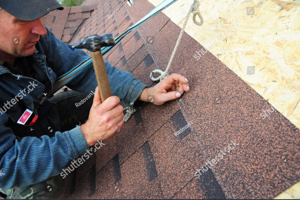 imgi 1 stock photo kyiv ukraine november roofing contractor laying asphalt shingles roofer with 1227556057