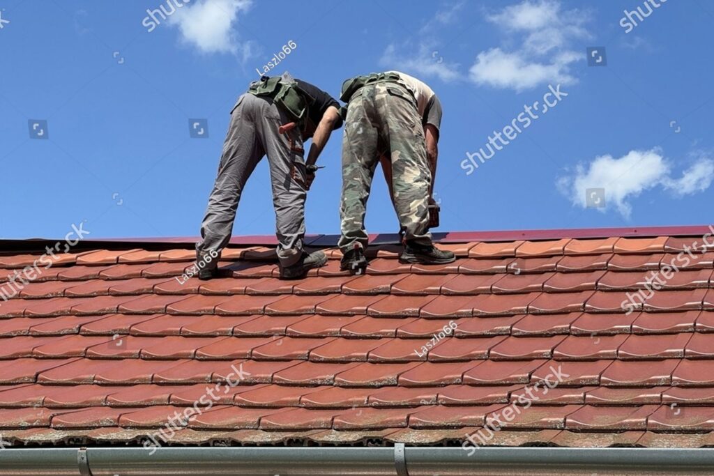 imgi 1 stock photo roofers are working on the roof of a house 2654899893